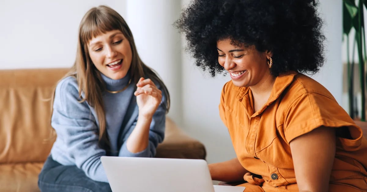 payroll-output-checker-female-employees-looking-at-laptop-smiling