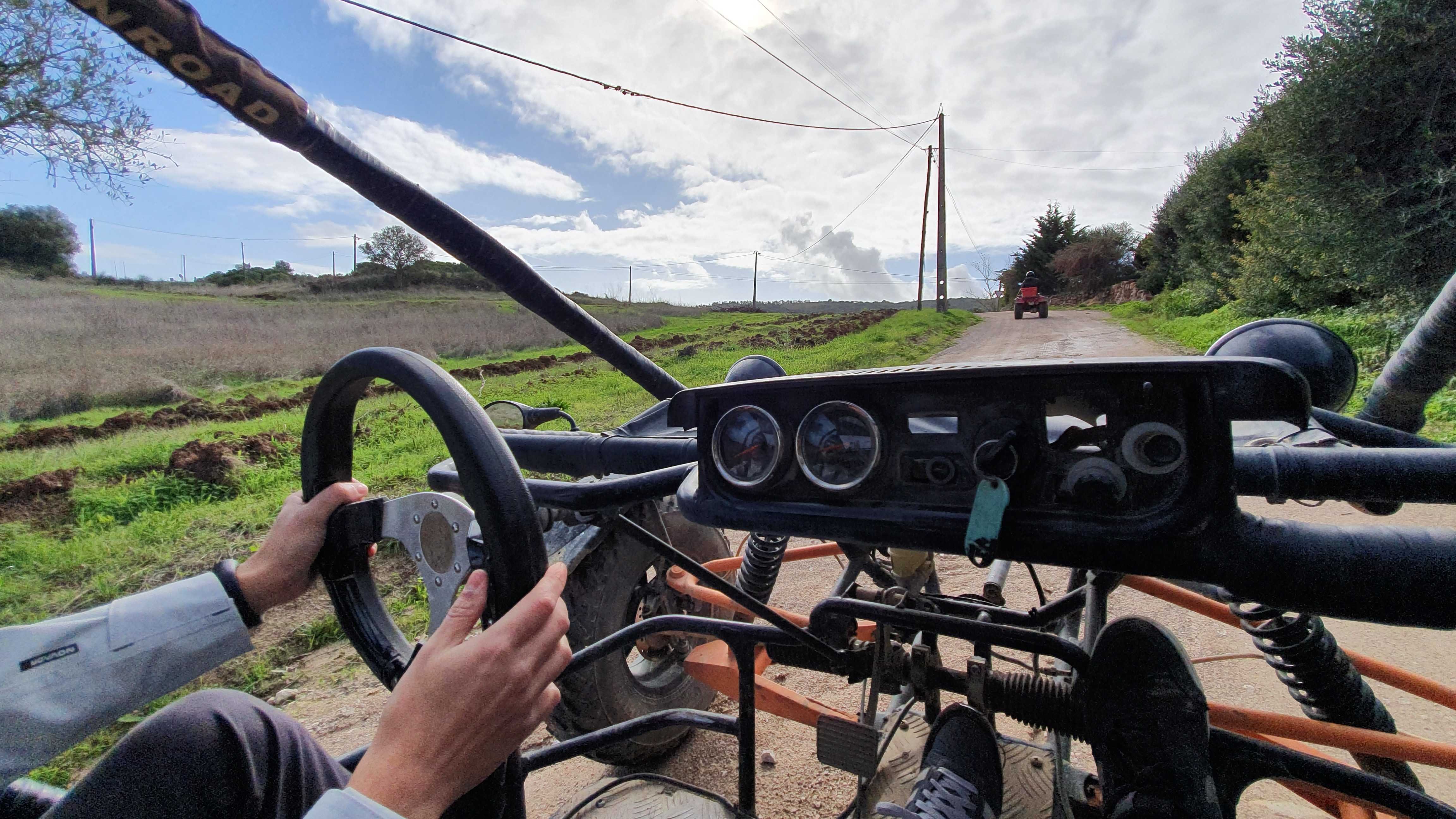 The picture is from one of the squad dynamics activities. It shows one person at the wheel of a car, driving on a road in the middle of a country.