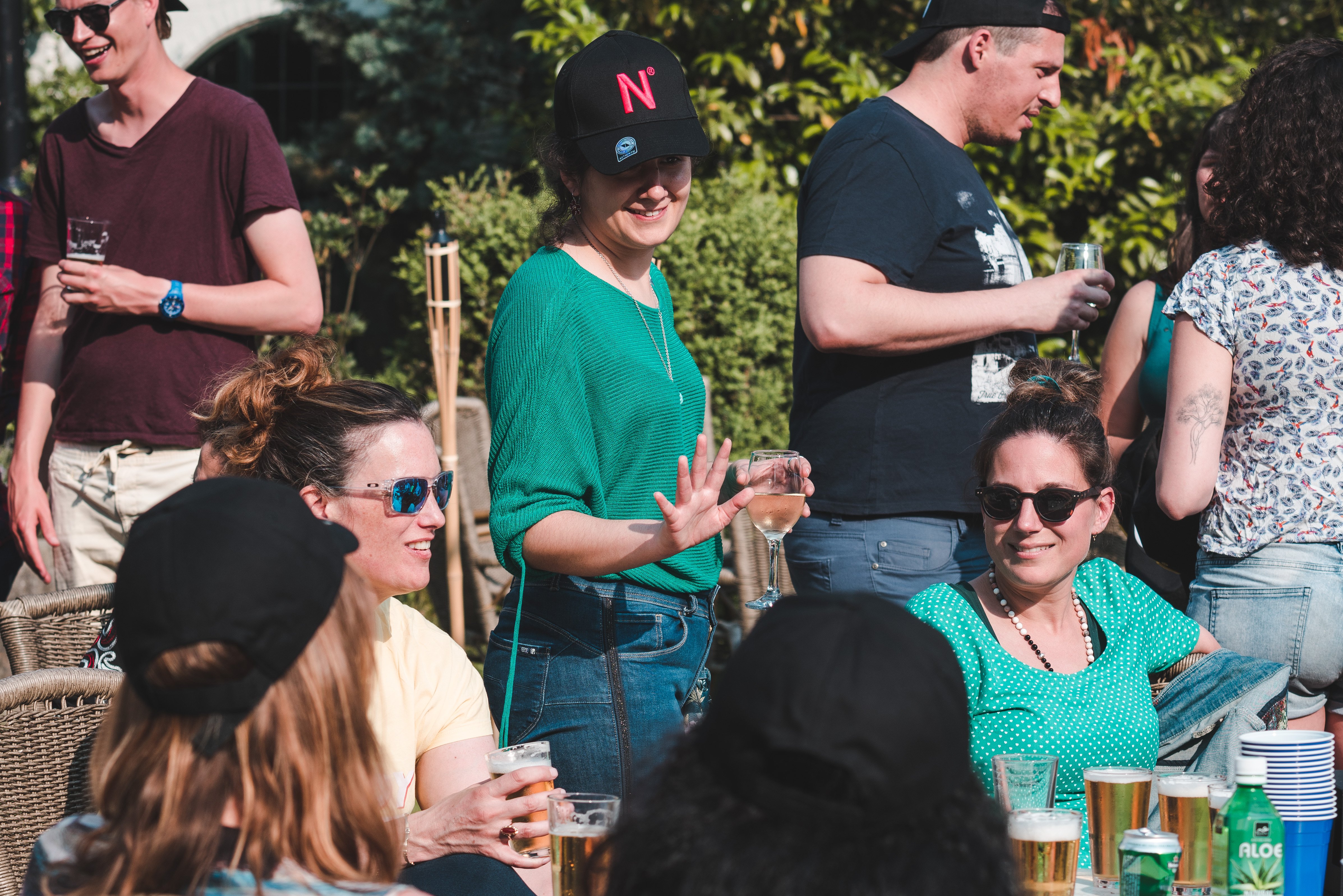 Rita, our Recruitment Lead, is talking to some of our colleagues during our Summer Event of 2019. They're sitting in a nice round table in the sun, drinking some beers and using the opportunity to connect to everyone.