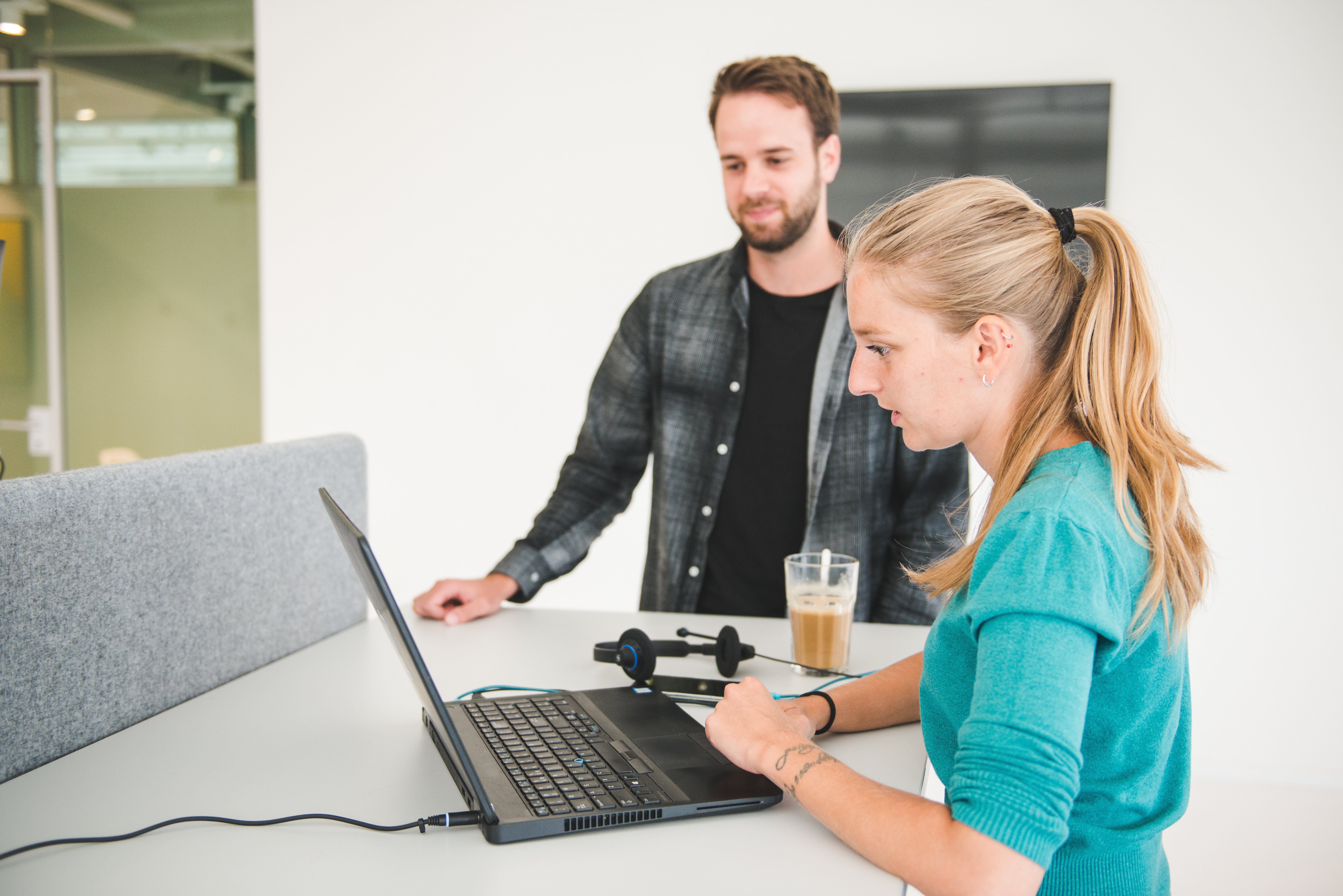 At Nmbrs, we work with multi-function teams. Our AI developer is showing something on the computer to our Content Marketeer.