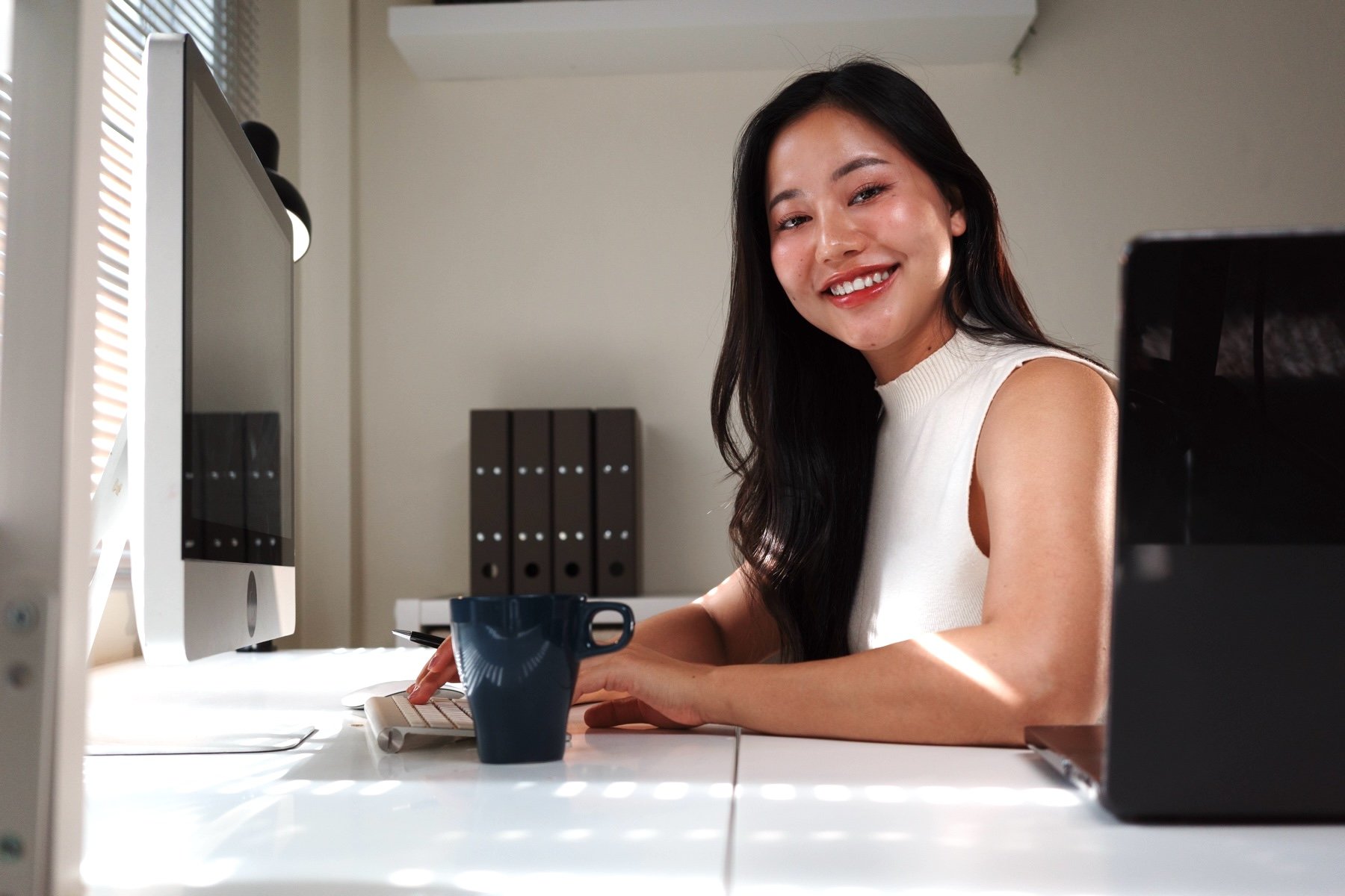 young-asian-businesswoman-smiling-and-working-from-2026-01-08-08-20-32-utc